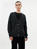 Man wearing a dark gray cardigan over a black shirt on a white background. #color_charcoal