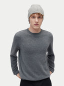 A person wearing a gray rib knit beanie hat. #color_soft-silver