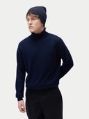 Unisex Cashmere Rib Knit Beanie Navy Blazer worn by model, side view on white background #color_navy