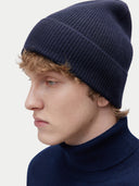 Unisex Cashmere Rib Knit Beanie Navy Blazer worn by model, detail view on white background #color_navy