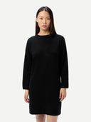 Women's Seamless Crewneck Cashmere Dress Black worn by model detail view on white background #color_black