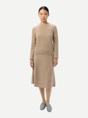 Women's A-Line Cashmere Knitted Skirt Warm Grey worn by model, front view on white background #color_dusty-beige