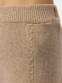 Women's A-Line Cashmere Knitted Skirt Warm Grey worn by model, detail view on white background #color_dusty-beige