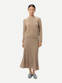 Women's Calf-Length Cashmere Skirt Warm Grey worn by model, front view on white background #color_dusty-beige