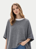 Women's Boat-Neck Cashmere Poncho Grey worn by model, detail view on white background #color_gray #ai-image