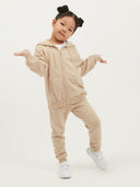 Child wearing a beige cashmere tracksuit on a white background #color_beige
