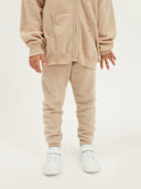 Child wearing a beige cashmere tracksuit on a white background #color_beige