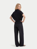 Women's Black Cashmere Asymmetrical Top worn by model, back view on white background #color_black