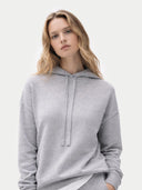 Women's Cashmere Pullover Hoodie High Rise worn by model, detail view on white background #color_light-gray #ai-image