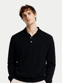 Men's Black Cashmere Polo Sweater worn by model, detail view on white background #color_black