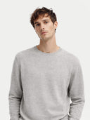 Man wearing a gray cashmere sweater on a white background. #color_steel_silver #ai-image