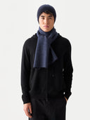 Person wearing a black hoodie, dark blue beanie, and matching scarf on a white background #color_navy