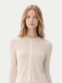 Woman wearing a beige ribbed sweater against a light background #color_pure-white #ai-image