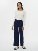 Navy blue ribbed knit scarf on a white background #color_navy