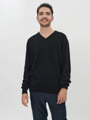 Men's Black Cashmere V-Neck Sweater worn by model, detail view on white background #color_black