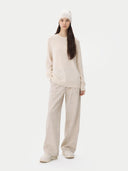 Person wearing a beige outfit with a beanie on a white background.  #color_off-white #ai-image
