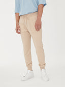 Men's Cashmere Jogger Beige worn by model, detail view on white background #color_beige