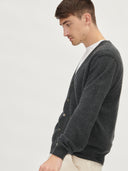A man wearing a gray V-neck cashmere cardigan with a round neckline and front button details. #color_charcoal