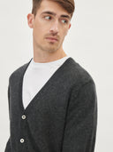 A man wearing a gray V-neck cashmere cardigan with a round neckline and front button details. #color_charcoal