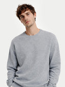 Men's Grey Crewneck Cashmere Sweater worn by model, detail view on white background #color_urban-silver #ai-image
