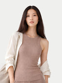Woman wearing a beige sleeveless top and light-colored cardigan on a white background. #color_taupe-brown #ai-image