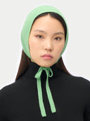 Green Cashmere Bonnet For Woman worn by model front view on white background #color_zephyr-green