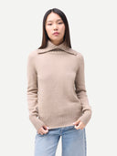 Women's Warm Grey Fold-Over Turtleneck Cashmere Sweater worn by model, detail view on white background #color_dusty-beige