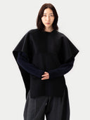 Versatile Cashmere Poncho Black worn by model, detail view, on white background #color_black