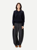 Barrel-Leg Cashmere Pants Charcoal worn by model, detail view on white background #color_charcoal