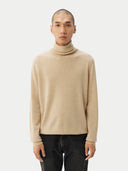 Men's Beige Cashmere Basic Turtle Neck Sweater Beige worn by model, detail view on white background #color_beige