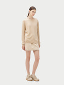 Women's Beige Cashmere Basic Crew Neck Sweater worn by model, side view on white background #color_beige