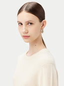 Women's White Cashmere Basic Crew Neck Sweater worn by model, detail view on white background #color_off-white