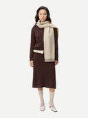 Women's Deep Mahogany A-Line Cashmere Knitted Skirt worn by model, front view on white background #color_mahogany-brown