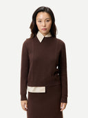 Women's Cropped Crewneck Cashmere Sweater Deep Mahogany worn by model, detail view on white background #color_mahogany-brown
