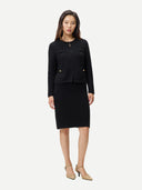 Black ribbed knit pencil cashmere skirt on a light gray background #color_black