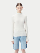 White ribbed knit cashmere sweater on a light beige background #color_pure-white