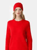 Woman wearing a red sweater and matching red beanie on a white background #color_hibiscus #ai-image