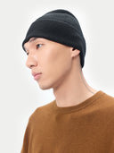 Unisex Black Cashmere Rib Knit Beanie worn by model, detail view on white background #color_black