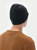 Unisex Black Cashmere Rib Knit Beanie worn by model, back view on white background #color_black
