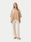 Women's Beige Cashmere Knitted Poncho worn by model, front view, on white background #color_beige #ai-image