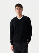 close up front view of a man wearing a black v-neck sweater and pants against a white background #color_black