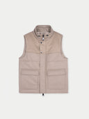 A sleeveless beige cashmere vest with a high collar, front zipper, and two large front flap pockets, shown flat against a light gray background. #color_taupe