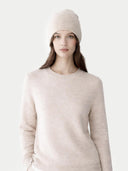 Woman wearing a beige beanie and sweater on a white background. #color_light-beige #ai-image