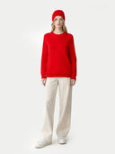 Person wearing a red sweater and pants with a white background #color_hibiscus #ai-image