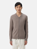 A gray knit zip-up cashmere bomber with a V-neck, ribbed cuffs and hem, and a sleeve pocket, shown against a light gray background. #color_cool-gray