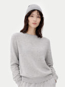 Person wearing a grey jumper and hat on a white background #color_urban-silver #ai-image