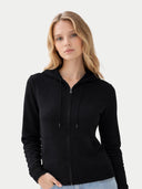 Woman Zipper Hoodie with Smiley Pocket Black worn by model, detail view on white background #color_black #ai-image