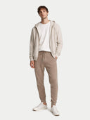 Men's Cashmere Jogger Taupe worn by model, front view on white background #color_taupe #ai-image