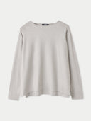 A light gray long-sleeve crewneck sweater displayed flat against a light gray background. #color_warm-light