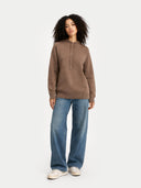 Person wearing a brown hoodie and blue jeans on a white background  #color_taupe #ai-image